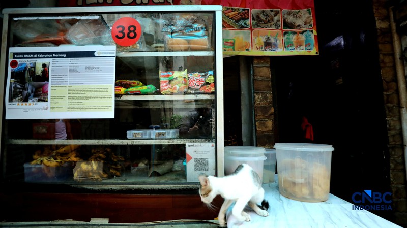 Warga menujukkan desain rumah yang tertera di halaman rumahnya, Kamis (26/2/2026). (CNBC Indonesia/Tri Susilo)