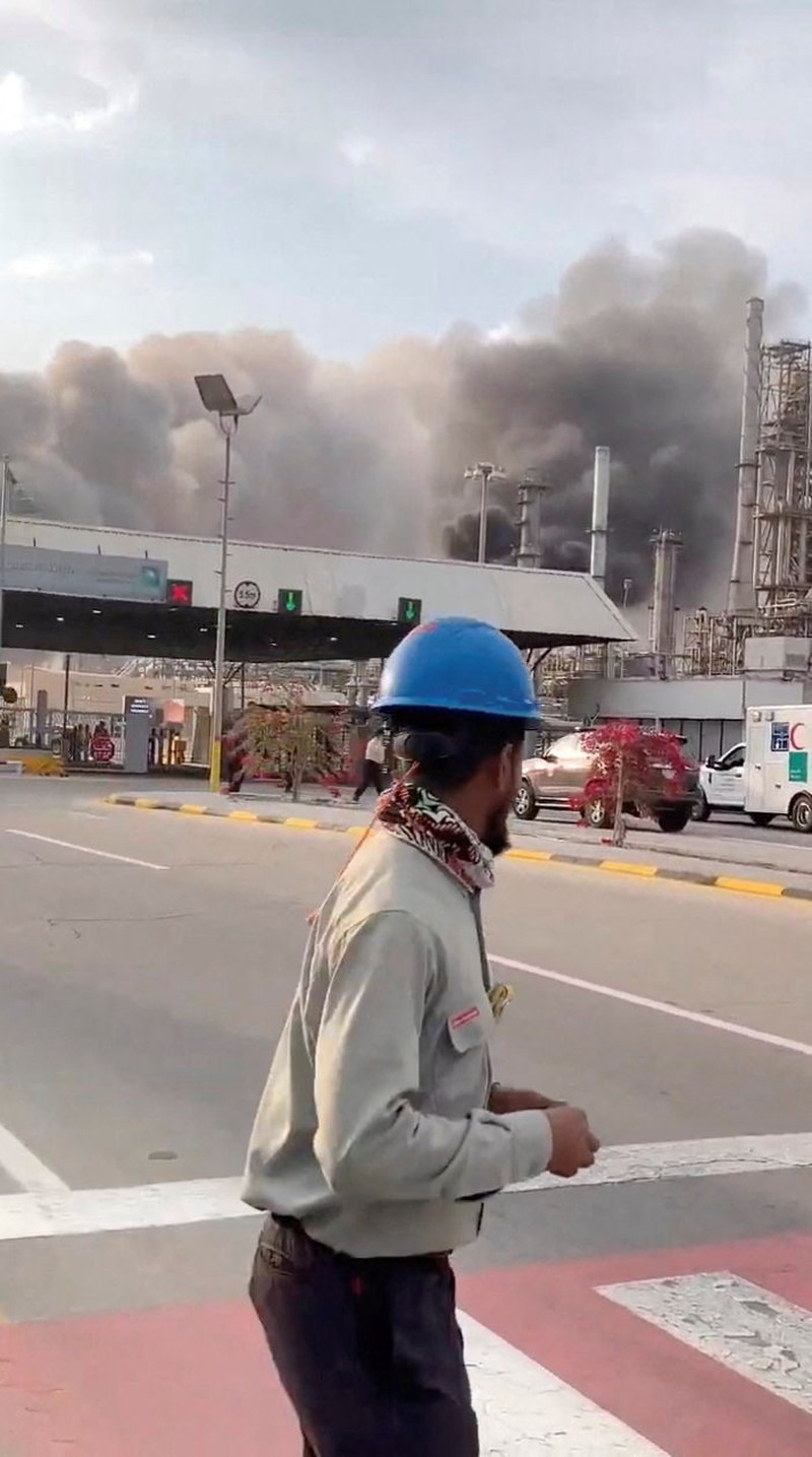 Workers evacuate area around Saudi Aramco's Ras Tanura oil refinery as smoke rises following a reported Iranian drone strike, in Ras Tanura, Saudi Arabia, in this still image obtained from social media video released on March 2, 2026. Social Media/via REUTERS  THIS IMAGE HAS BEEN SUPPLIED BY A THIRD PARTY. NO RESALES. NO ARCHIVES. NEWS USE ONLY. VERIFICATION: Reuters verified the location from the buildings, trees and the smoke stacks seen in the video, which matched satellite imagery of the area. The date was verified from an official statement from Aramco saying it had shut the facility down after a drone strike on March 2. No older versions of the videos were found posted online before March 2. Coordinates: 26.70322602981727, 50.090750650948635.