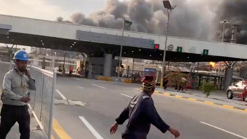 Workers evacuate area around Saudi Aramco's Ras Tanura oil refinery as smoke rises following a reported Iranian drone strike, in Ras Tanura, Saudi Arabia, in this still image obtained from social media video released on March 2, 2026. Social Media/via REUTERS  THIS IMAGE HAS BEEN SUPPLIED BY A THIRD PARTY. NO RESALES. NO ARCHIVES. NEWS USE ONLY. VERIFICATION: Reuters verified the location from the buildings, trees and the smoke stacks seen in the video, which matched satellite imagery of the area. The date was verified from an official statement from Aramco saying it had shut the facility down after a drone strike on March 2. No older versions of the videos were found posted online before March 2. Coordinates: 26.70322602981727, 50.090750650948635.