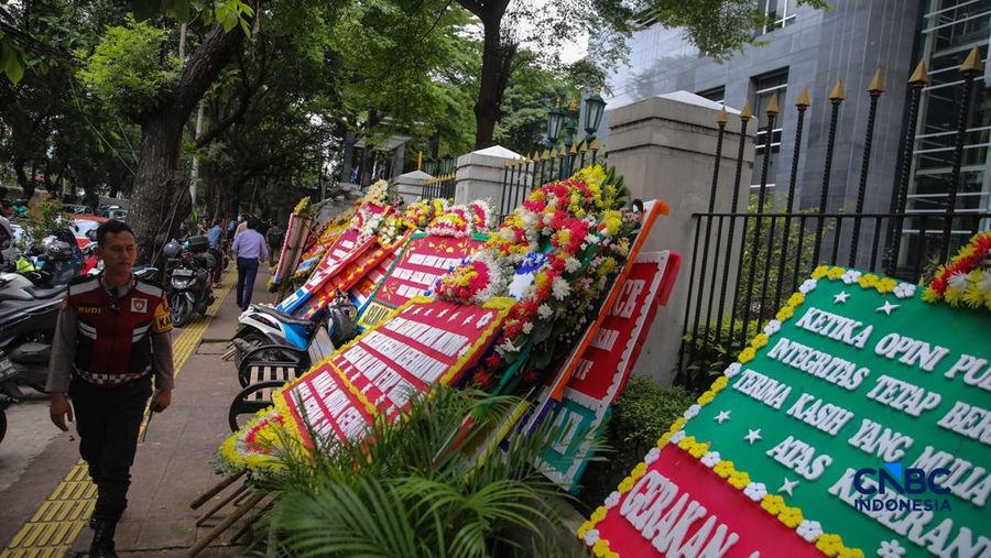 Warga berjalan di dekat deretan karangan bunga dukungan untuk Hakim anggota Mulyono di depan Pengadilan Tipikor, Jakarta, Rabu (4/3/2026). (CNBC Indonesia/Faisal Rahman)
