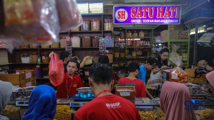 Pedagang kue kering dan kue lebaran melayani pembeli yang dijual di Pasar Jatinegara, Jakarta, Senin (9/3/2026). (CNBC Indonesia/Faisal Rahman)