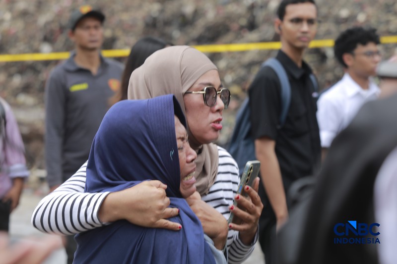 Sejumlah petugas mengevakuasi jenazah dengan kantung saat melakukan pencarian korban longsor gunungan sampah di Tempat Pengolahan Sampah Terpadu (TPST) Bantargebang, Bekasi, Jawa Barat, Senin (9/3/2026). (CNBC Indonesia/Muhammad Sabki)