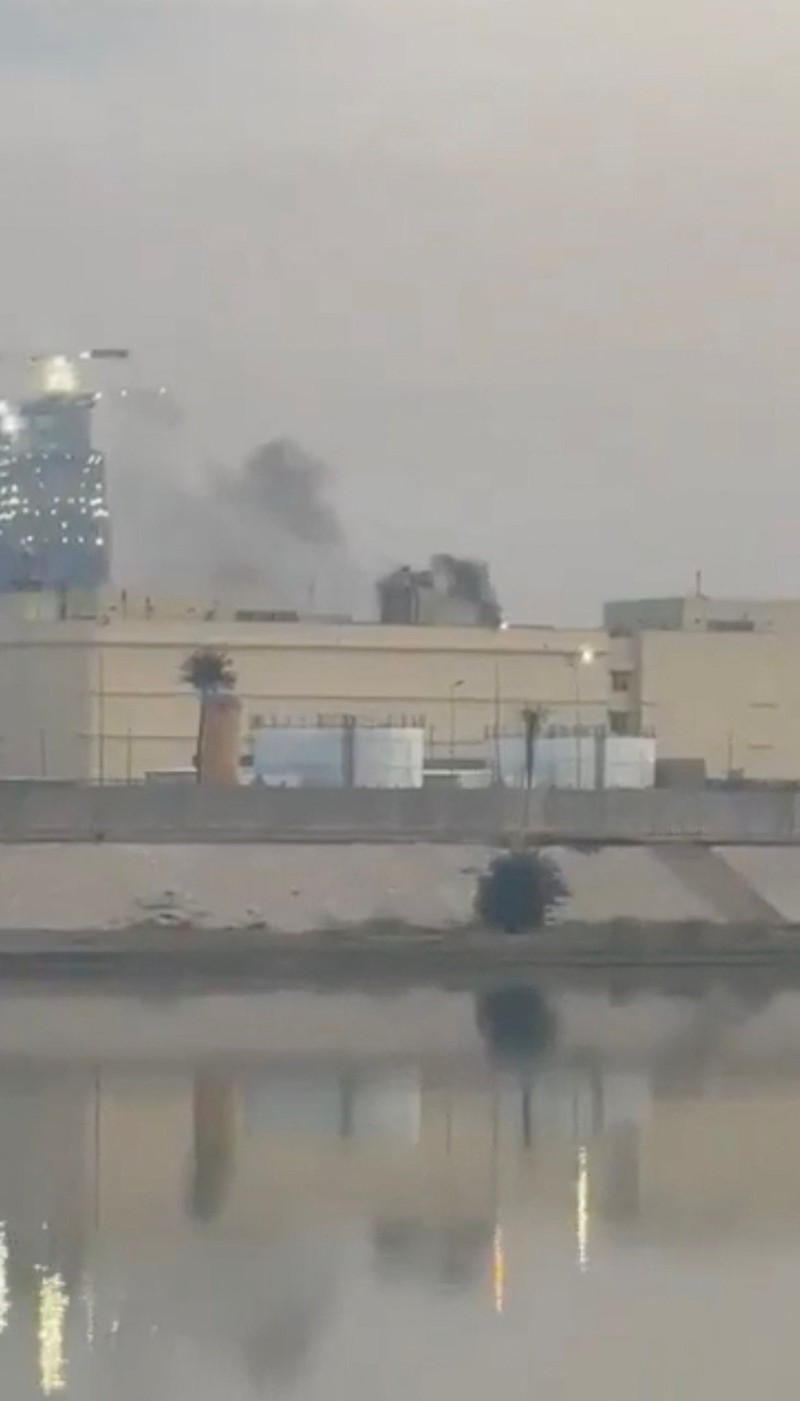 Smoke rises from the U.S. embassy building, after Iraqi security sources said the embassy was hit in a missile attack, in Baghdad, Iraq March 14, 2026 in this screen grab obtained from a social media video. SOCIAL MEDIA/via REUTERS  THIS IMAGE HAS BEEN SUPPLIED BY A THIRD PARTY.  NEWS USE ONLY. NO RESALES. NO ARCHIVES. BEST QUALITY AVAILABLE. VERIFICATION - Reuters was able to confirm the video from the shape and location of buildings and a water body which matched file and satellite imagery of the area. Date was verified by Iraqi security sources and media reports. Multiple corroborating videos showed smoke rising from the building. No older versions of the video were found posted online before March 14
