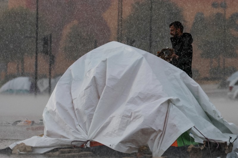Rain falls over tents used by displaced people on a street along the corniche overlooking the sea, following an escalation between Hezbollah and Israel, amid the U.S.-Israeli conflict with Iran, in Beirut, Lebanon, March 15, 2026. REUTERS/Amr Abdallah Dalsh