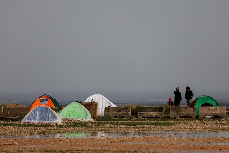 Rain falls over tents used by displaced people on a street along the corniche overlooking the sea, following an escalation between Hezbollah and Israel, amid the U.S.-Israeli conflict with Iran, in Beirut, Lebanon, March 15, 2026. REUTERS/Amr Abdallah Dalsh