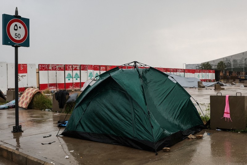 Rain falls over tents used by displaced people on a street along the corniche overlooking the sea, following an escalation between Hezbollah and Israel, amid the U.S.-Israeli conflict with Iran, in Beirut, Lebanon, March 15, 2026. REUTERS/Amr Abdallah Dalsh