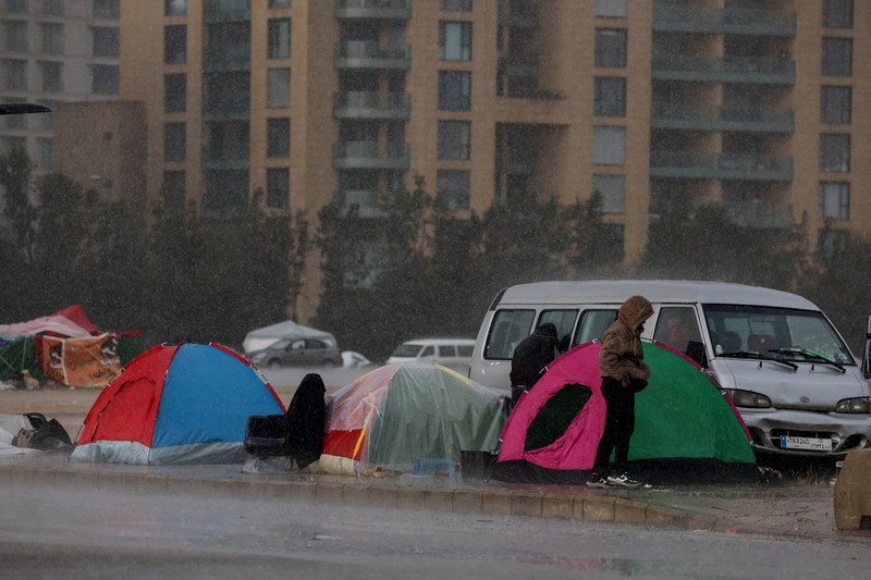 Rain falls over tents used by displaced people on a street along the corniche overlooking the sea, following an escalation between Hezbollah and Israel, amid the U.S.-Israeli conflict with Iran, in Beirut, Lebanon, March 15, 2026. REUTERS/Amr Abdallah Dalsh