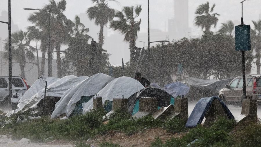 Rain falls over tents used by displaced people on a street along the corniche overlooking the sea, following an escalation between Hezbollah and Israel, amid the U.S.-Israeli conflict with Iran, in Beirut, Lebanon, March 15, 2026. REUTERS/Amr Abdallah Dalsh