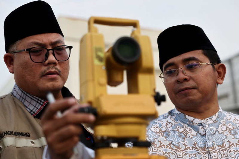 Petugas mengamati posisi bulan menjelang Idul Fitri, yang menandai berakhirnya bulan suci puasa Ramadhan, di Jakarta, Kamis (19/3/2026). (REUTERS/Willy Kurniawan)