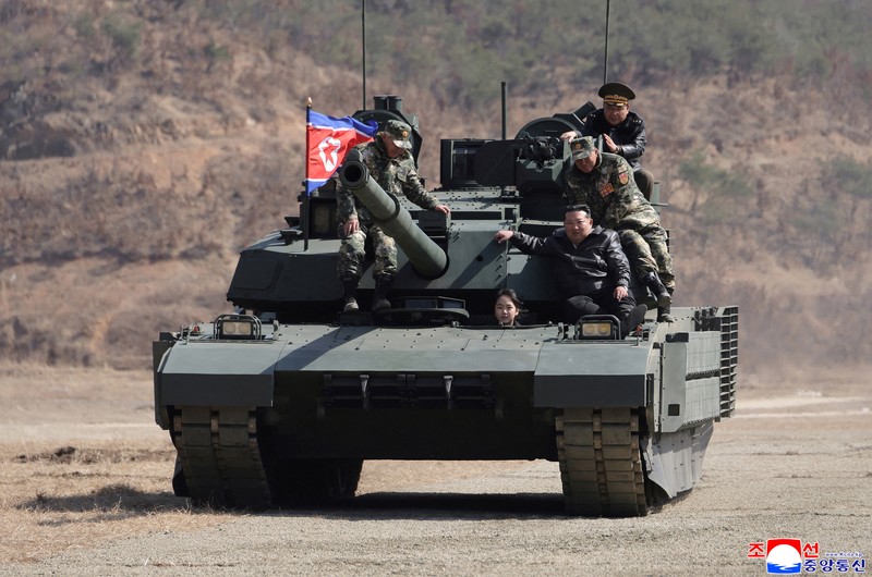 North Korean leader Kim Jong Un and his daughter Kim Ju Ae ride a tank during what North Korean state news agency KCNA reports is an offensive tactical drill involving a new type of tank, at a training base in Pyongyang, North Korea, March 19, 2026, in this picture released by North Korea's official Korean Central News Agency. KCNA via REUTERS ATTENTION EDITORS - THIS IMAGE WAS PROVIDED BY A THIRD PARTY. REUTERS IS UNABLE TO INDEPENDENTLY VERIFY THIS IMAGE. NO THIRD PARTY SALES. SOUTH KOREA OUT. NO COMMERCIAL OR EDITORIAL SALES IN SOUTH KOREA.     TPX IMAGES OF THE DAY