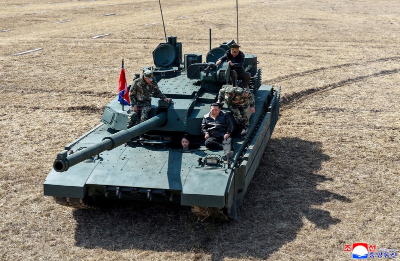North Korean leader Kim Jong Un and his daughter Kim Ju Ae ride a tank during what North Korean state news agency KCNA reports is an offensive tactical drill involving a new type of tank, at a training base in Pyongyang, North Korea, March 19, 2026, in this picture released by North Korea's official Korean Central News Agency. KCNA via REUTERS ATTENTION EDITORS - THIS IMAGE WAS PROVIDED BY A THIRD PARTY. REUTERS IS UNABLE TO INDEPENDENTLY VERIFY THIS IMAGE. NO THIRD PARTY SALES. SOUTH KOREA OUT. NO COMMERCIAL OR EDITORIAL SALES IN SOUTH KOREA.     TPX IMAGES OF THE DAY