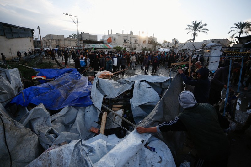 Smoke and flames rise following an Israeli strike near a tent camp sheltering displaced Palestinians in Deir al-Balah, central Gaza Strip, March 25, 2026. The Israeli military ordered camp to evacuate before the strike, according to residents. REUTERS/Stringer