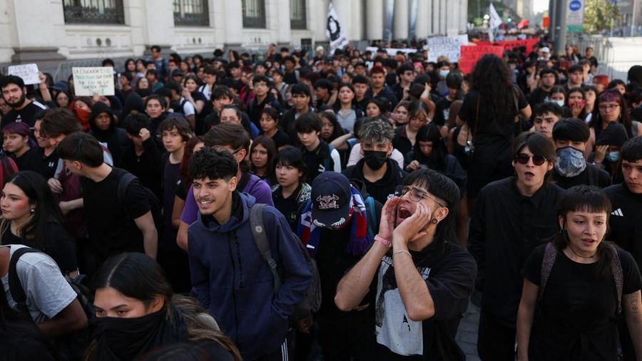 A demonstrator throws an object as a water cannon is used during a protest against the Chilean government's budget cuts to education, in Santiago, Chile, March 26, 2026. REUTERS/Pablo Sanhueza