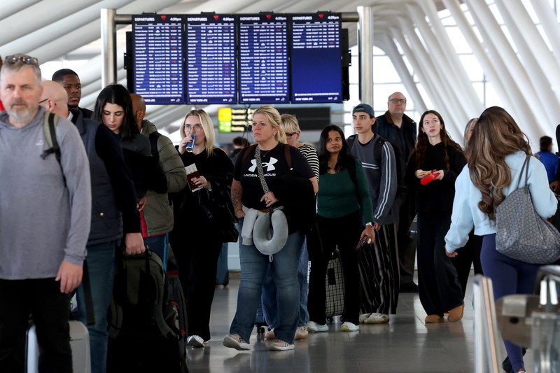 People wait in TSA security lines at New York's John F. Kennedy International Airport in Queens, New York City, U.S., March 26, 2026. Picture taken with a phone. REUTERS/Brendan McDermid