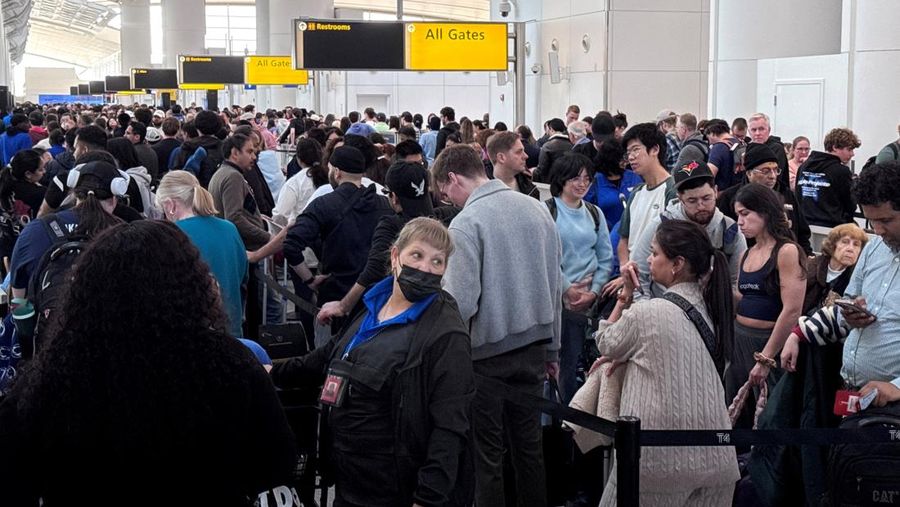 People wait in TSA security lines at New York's John F. Kennedy International Airport in Queens, New York City, U.S., March 26, 2026. Picture taken with a phone. REUTERS/Brendan McDermid
