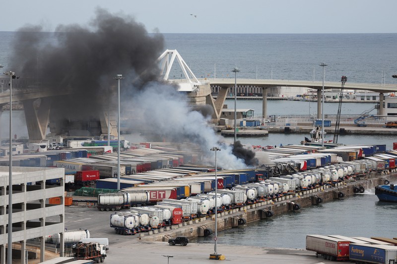 Petugas pemadam kebakaran berupaya memadamkan api di pelabuhan Barcelona setelah sebuah kendaraan dan beberapa kontainer pelabuhan terbakar, di Barcelona, ​​Spanyol, 29 Maret 2026. REUTERS/Bruna Casas