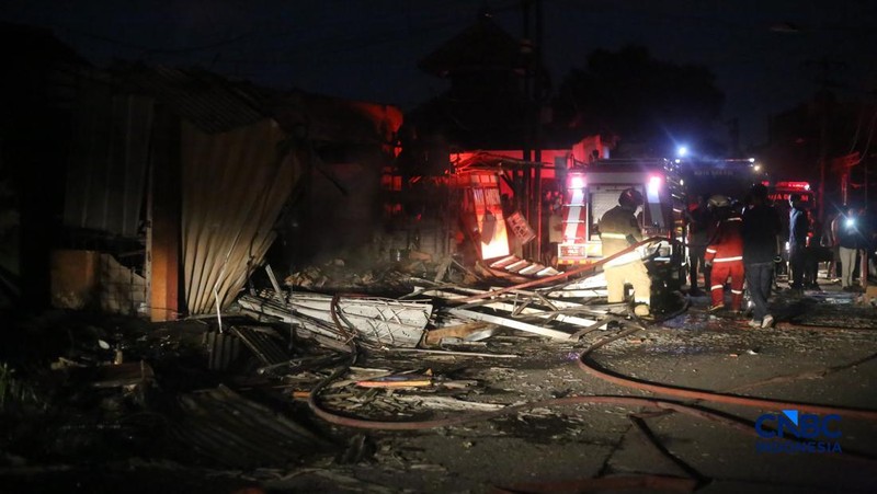 Petugas pemadam kebakaran berusaha memadamkan api pada bangunan yang terdampak setelah Stasiun Pengisian Bulk Elpiji (SPBE) di Cimuning, Mustika Jaya, Bekasi, mengalami kebakaran hebat pada Rabu (1/4/2026) malam. (CNBC Indonesia/Tias Budiarto)