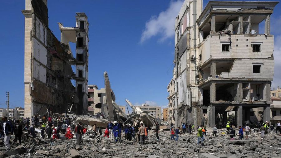 Orang-orang berkumpul saat tim penyelamat bekerja di lokasi serangan Israel di Sidon, Lebanon, Rabu (8/4/2026). (REUTERS/Stringer)