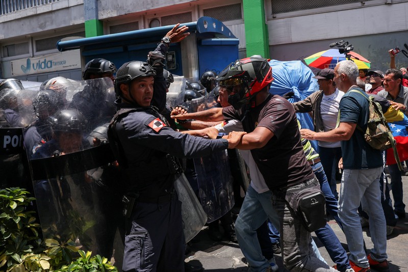 Para pekerja sektor publik bentrok dengan Kepolisian Nasional Bolivarian selama protes yang menuntut upah lebih tinggi dan kondisi kerja yang lebih baik, di Caracas, Venezuela, 9 April 2026. (REUTERS/Leonardo Fernandez Viloria)