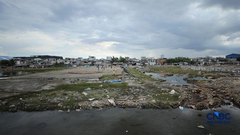 Sejumlah warga beraktivitas di area tanggul Pantai Muara Baru, Jakarta, Jumat (10/4/2026). (CNBC Indonesia/Tri Susilo)