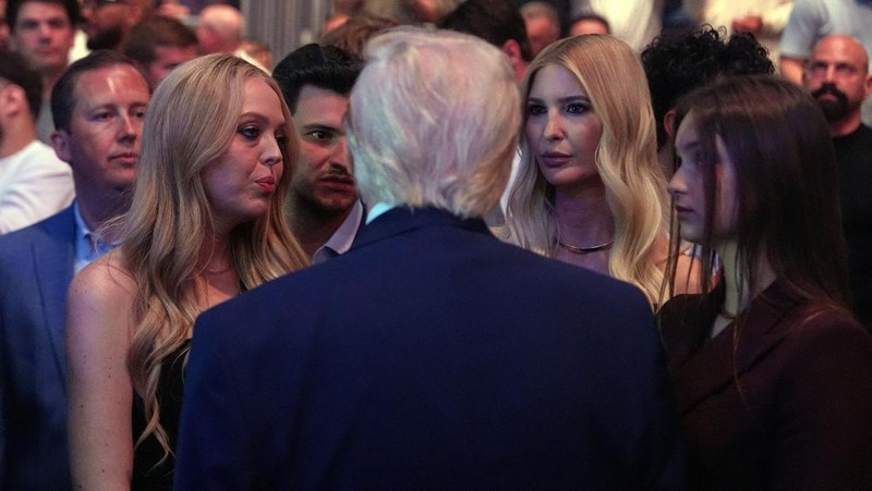 U.S. President Donald Trump and Hunter Campbell, chief business officer of the UFC, watch a match during the UFC 327 event at Kaseya Center in Miami, Florida, U.S., April 11, 2026.  REUTERS/Kevin Lamarque