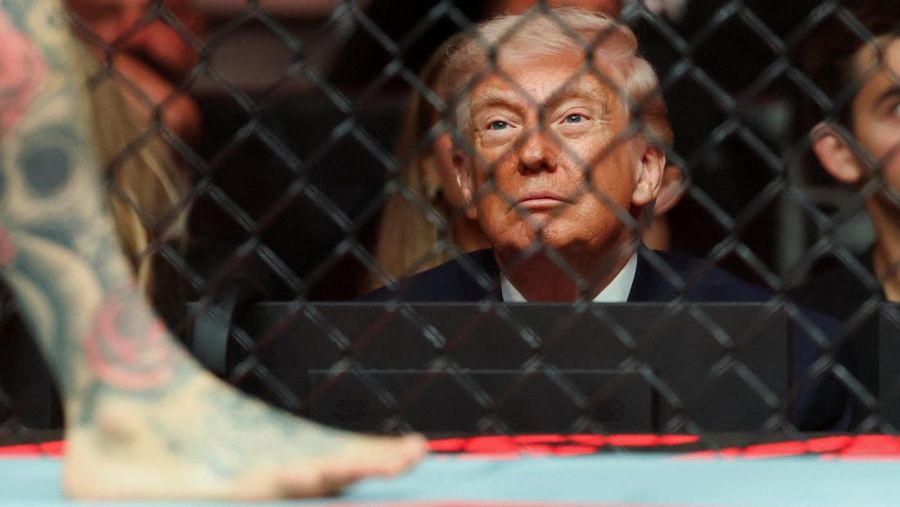 Apr 11, 2026; Miami, Florida, UNITED STATES;  President of the United States Donald Trump reacts after the fight between Cub Swanson (red gloves) and Nate Landwehr (blue gloves) during UFC 327 at Kaseya Center. Mandatory Credit: Sam Navarro-Imagn Images