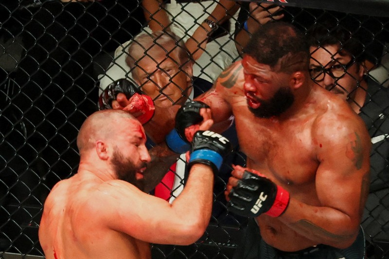 U.S. President Donald Trump and Hunter Campbell, chief business officer of the UFC, watch a match during the UFC 327 event at Kaseya Center in Miami, Florida, U.S., April 11, 2026.  REUTERS/Kevin Lamarque
