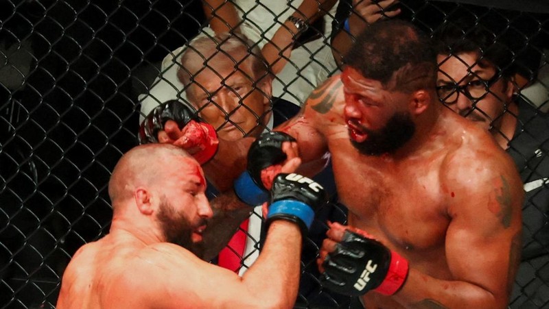 U.S. President Donald Trump and Hunter Campbell, chief business officer of the UFC, watch a match during the UFC 327 event at Kaseya Center in Miami, Florida, U.S., April 11, 2026.  REUTERS/Kevin Lamarque