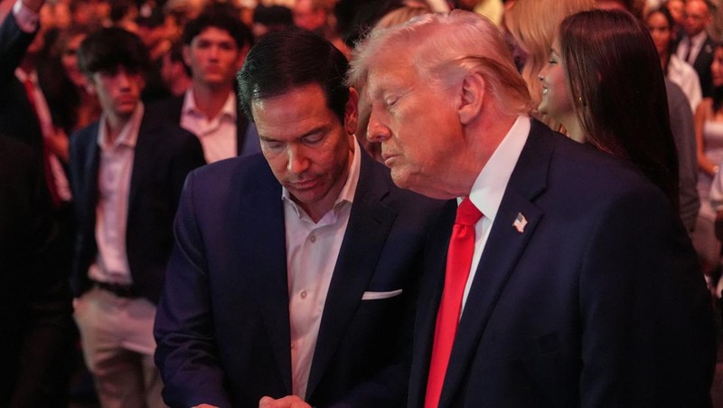 U.S. President Donald Trump and Hunter Campbell, chief business officer of the UFC, watch a match during the UFC 327 event at Kaseya Center in Miami, Florida, U.S., April 11, 2026.  REUTERS/Kevin Lamarque