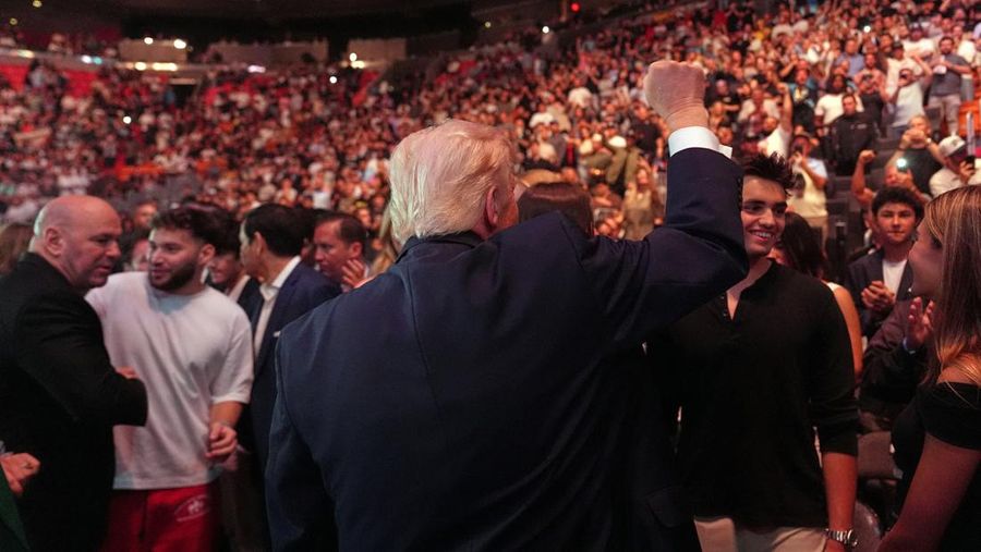 U.S. President Donald Trump and Hunter Campbell, chief business officer of the UFC, watch a match during the UFC 327 event at Kaseya Center in Miami, Florida, U.S., April 11, 2026.  REUTERS/Kevin Lamarque
