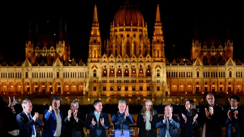 Peter Magyar, leader of the opposition Tisza party, and other officials celebrate following the partial results of the parliamentary election, in Budapest, Hungary, April 12, 2026. REUTERS/Marton Monus     TPX IMAGES OF THE DAY