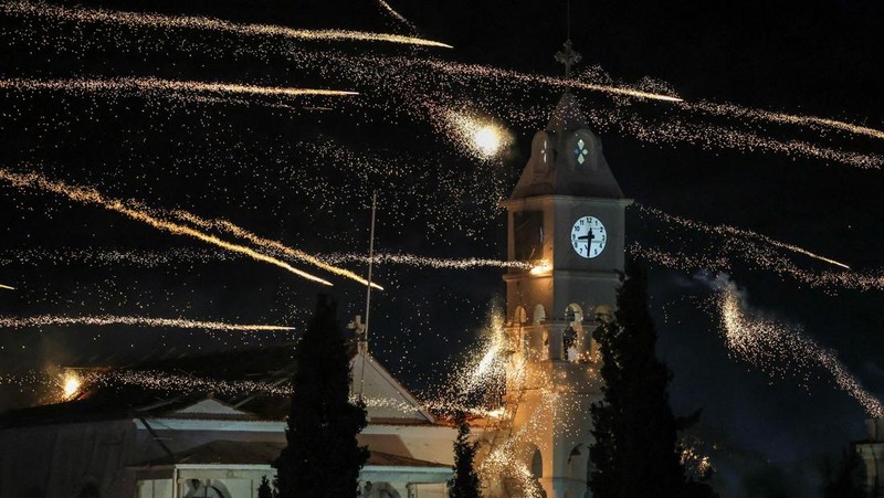 A man ignites handmade rockets during Greek Orthodox Easter celebrations in the village of Vrontados, on the island of Chios, Greece, April 11, 2026. REUTERS/Konstantinos Anagnostou