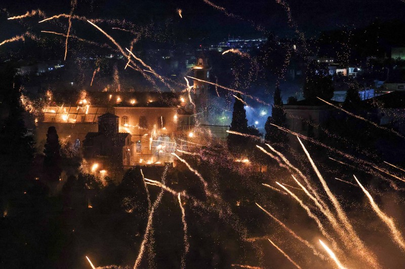A man ignites handmade rockets during Greek Orthodox Easter celebrations in the village of Vrontados, on the island of Chios, Greece, April 11, 2026. REUTERS/Konstantinos Anagnostou