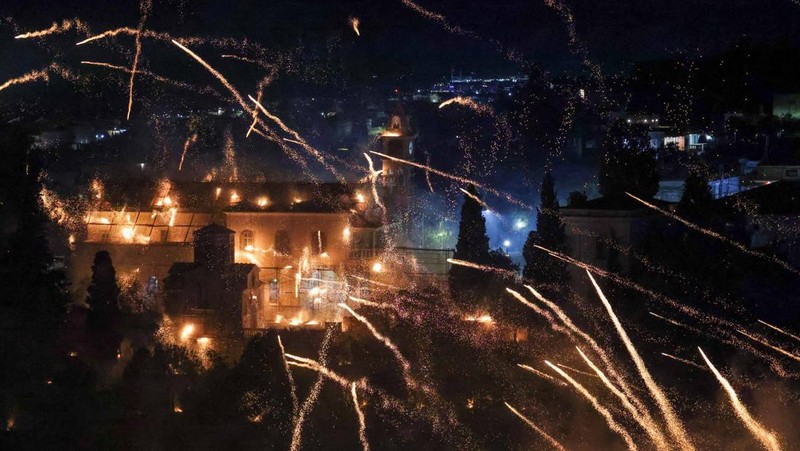 A man ignites handmade rockets during Greek Orthodox Easter celebrations in the village of Vrontados, on the island of Chios, Greece, April 11, 2026. REUTERS/Konstantinos Anagnostou