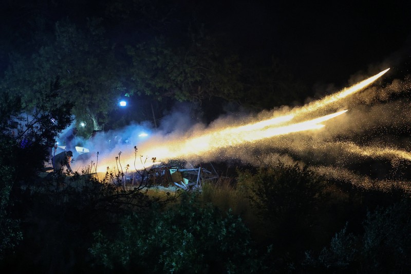 A man ignites handmade rockets during Greek Orthodox Easter celebrations in the village of Vrontados, on the island of Chios, Greece, April 11, 2026. REUTERS/Konstantinos Anagnostou