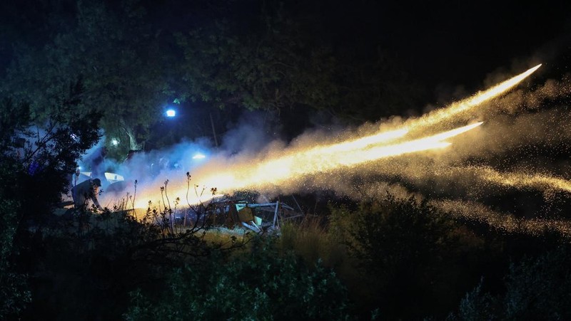 A man ignites handmade rockets during Greek Orthodox Easter celebrations in the village of Vrontados, on the island of Chios, Greece, April 11, 2026. REUTERS/Konstantinos Anagnostou