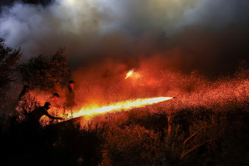 A man ignites handmade rockets during Greek Orthodox Easter celebrations in the village of Vrontados, on the island of Chios, Greece, April 11, 2026. REUTERS/Konstantinos Anagnostou