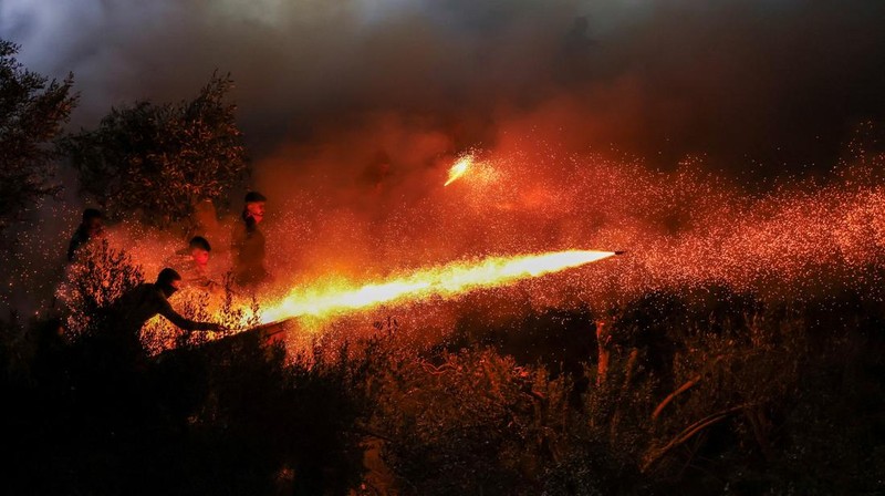 A man ignites handmade rockets during Greek Orthodox Easter celebrations in the village of Vrontados, on the island of Chios, Greece, April 11, 2026. REUTERS/Konstantinos Anagnostou