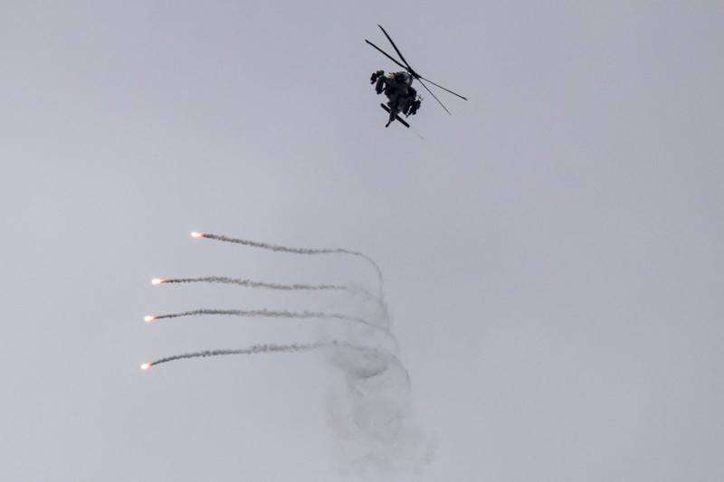 An Israeli helicopter releases flares, near the Israel-Lebanon border, as seen from the Israeli side of the border in northern Israel, April 14, 2026. REUTERS/Florion Goga REFILE - QUALITY REPEAT     TPX IMAGES OF THE DAY