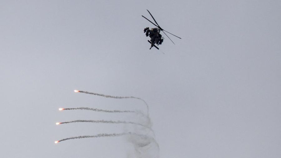 An Israeli helicopter releases flares, near the Israel-Lebanon border, as seen from the Israeli side of the border in northern Israel, April 14, 2026. REUTERS/Florion Goga REFILE - QUALITY REPEAT     TPX IMAGES OF THE DAY