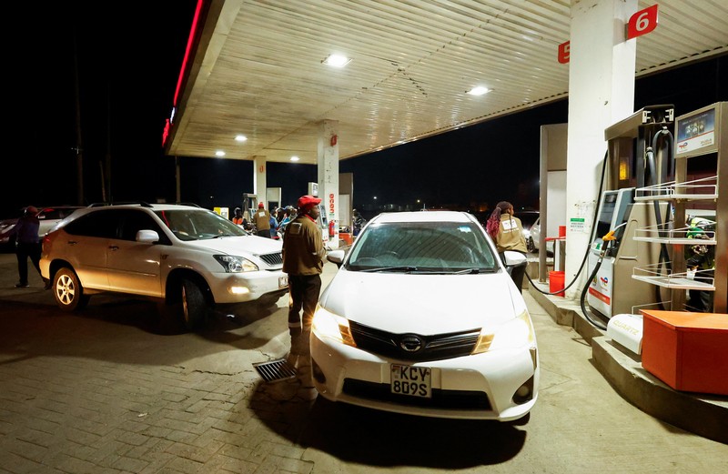 A fuel pump attendant confirms a mobile phone payment as he fuels a motorcycle taxi at a TotalEnergies petrol station ahead of an announced fuel price hike, as fuel costs rise amid global disruptions caused by the Iran war, in Nairobi, Kenya April 14, 2026. REUTERS/Thomas Mukoya