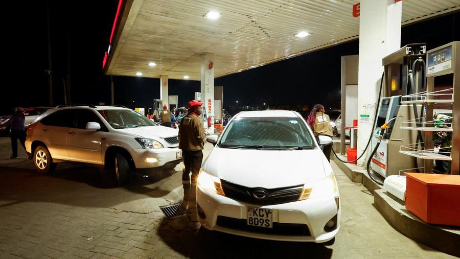 A fuel pump attendant confirms a mobile phone payment as he fuels a motorcycle taxi at a TotalEnergies petrol station ahead of an announced fuel price hike, as fuel costs rise amid global disruptions caused by the Iran war, in Nairobi, Kenya April 14, 2026. REUTERS/Thomas Mukoya