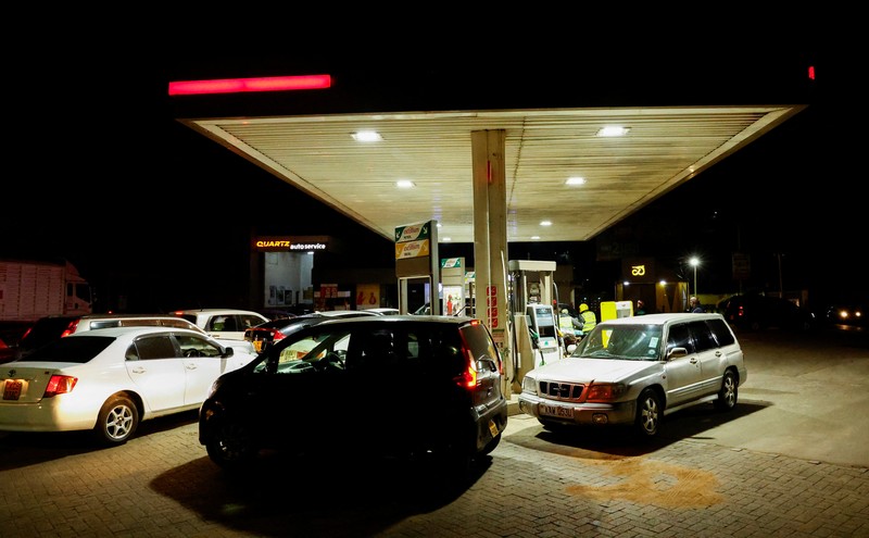 A fuel pump attendant confirms a mobile phone payment as he fuels a motorcycle taxi at a TotalEnergies petrol station ahead of an announced fuel price hike, as fuel costs rise amid global disruptions caused by the Iran war, in Nairobi, Kenya April 14, 2026. REUTERS/Thomas Mukoya