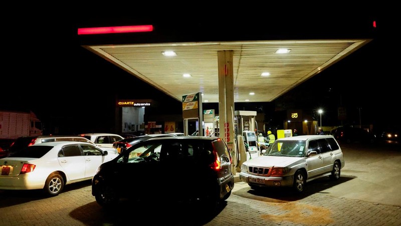 A fuel pump attendant confirms a mobile phone payment as he fuels a motorcycle taxi at a TotalEnergies petrol station ahead of an announced fuel price hike, as fuel costs rise amid global disruptions caused by the Iran war, in Nairobi, Kenya April 14, 2026. REUTERS/Thomas Mukoya