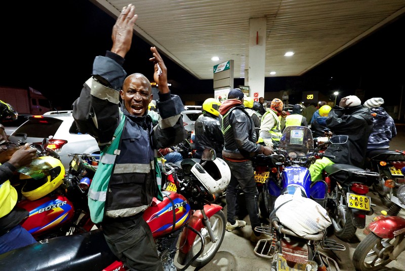 A fuel pump attendant confirms a mobile phone payment as he fuels a motorcycle taxi at a TotalEnergies petrol station ahead of an announced fuel price hike, as fuel costs rise amid global disruptions caused by the Iran war, in Nairobi, Kenya April 14, 2026. REUTERS/Thomas Mukoya