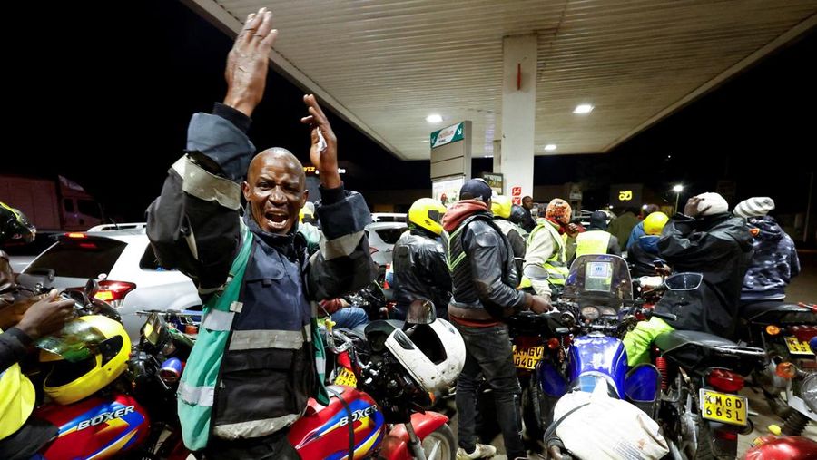 A fuel pump attendant confirms a mobile phone payment as he fuels a motorcycle taxi at a TotalEnergies petrol station ahead of an announced fuel price hike, as fuel costs rise amid global disruptions caused by the Iran war, in Nairobi, Kenya April 14, 2026. REUTERS/Thomas Mukoya