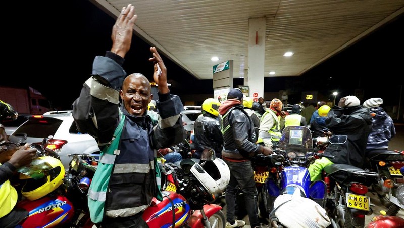 A fuel pump attendant confirms a mobile phone payment as he fuels a motorcycle taxi at a TotalEnergies petrol station ahead of an announced fuel price hike, as fuel costs rise amid global disruptions caused by the Iran war, in Nairobi, Kenya April 14, 2026. REUTERS/Thomas Mukoya