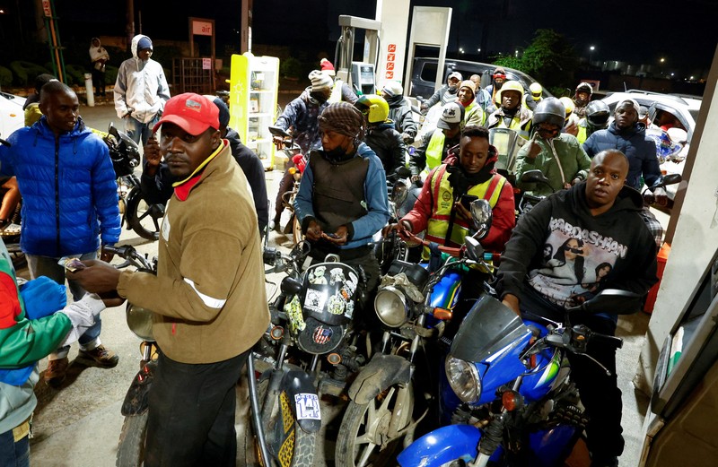 A fuel pump attendant confirms a mobile phone payment as he fuels a motorcycle taxi at a TotalEnergies petrol station ahead of an announced fuel price hike, as fuel costs rise amid global disruptions caused by the Iran war, in Nairobi, Kenya April 14, 2026. REUTERS/Thomas Mukoya