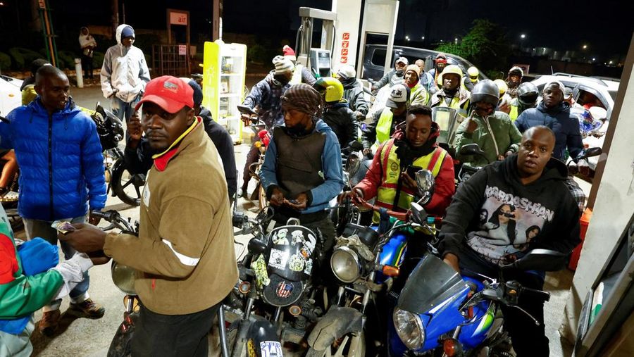 A fuel pump attendant confirms a mobile phone payment as he fuels a motorcycle taxi at a TotalEnergies petrol station ahead of an announced fuel price hike, as fuel costs rise amid global disruptions caused by the Iran war, in Nairobi, Kenya April 14, 2026. REUTERS/Thomas Mukoya