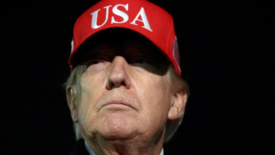 U.S. President Donald Trump looks on after disembarking Air Force One as he arrives at Joint Base Andrews in Maryland, U.S., April 12, 2026.  REUTERS/Kevin Lamarque
